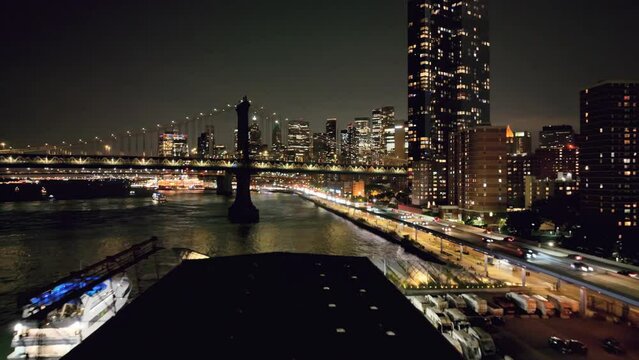 low flying over pier 35 toward bridge East River water cars driving FDR Drive Manhattan New York City NYC