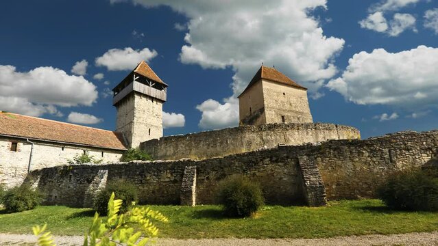 White clouds on blue sky over Calnic fortress in Transylvania, timelapse
