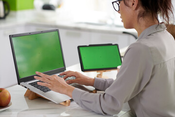 Cropped shot of young female freelancer typing on laptop keypad