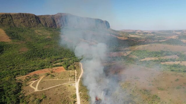 Drone view of Forest fire in Cerrado biome with Atlantic Forest transition near Casca d'Anta waterfall in Serra da Canastra National Park