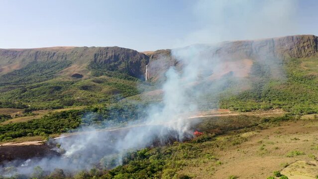Drone view of Forest fire in Cerrado biome with Atlantic Forest transition near Casca d'Anta waterfall in Serra da Canastra National Park
