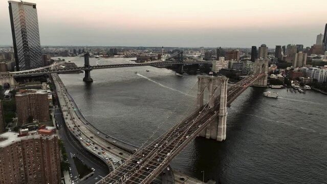 aerial flying over half staff American flag Brooklyn Bridge Two Bridges East River New York City NYC