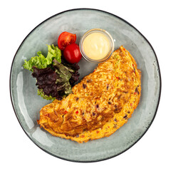 Portion of omelette with salad and sauce