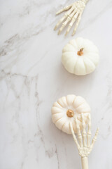 white halloween pumpkins with decor on marble background