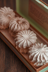 Meringue cake in a gift box. Pink meringue with berries in a vintage box. Dessert Background. Merengue.