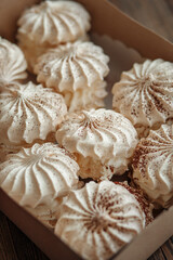 Fototapeta na wymiar A set of meringue cake in a craft box. Dessert Background.Merengue