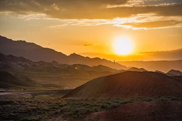 Photo sur Plexiglas Zhangye Danxia Warm sunset over the beautiful Dangxia Landforms, between the Gobi Desert and the Qilian Mountains. Gansu Province. China