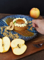 Apple tart with fresh apples on wooden table