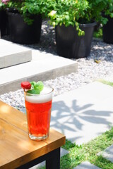 a glass of red drinks on the table 