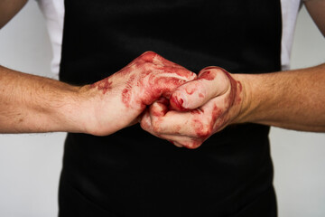 Man with bloody hands isolated on white - obrazy, fototapety, plakaty