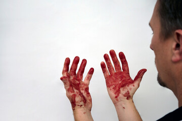 Man looking on his bloody hand isolated on white - obrazy, fototapety, plakaty