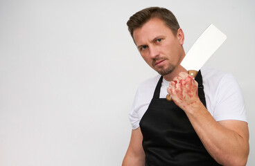 Young man with bloody hands holding axe.