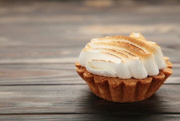 Appetizing lemon cupcakes with white cream on brown background. Holiday, surprise, birthday, Valentine's Day.
