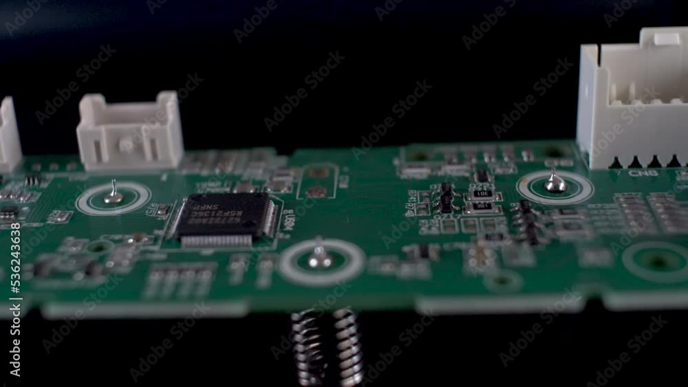 Poster close up dolly shot of side view of complex printed circuit board, an important hardware component f