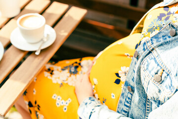 Pregnant woman drink coffee. Lifestyle morning with happy pregnancy girl drink espresso coffee. Concept for coffee product advertising.