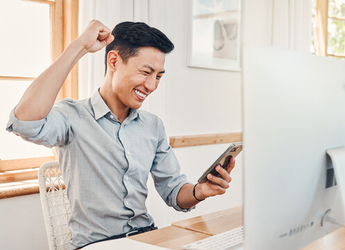 Happy, Excited And Celebration, Man With Phone In Startup Office Gets Text Or Email With News On Investment Reward. Success, Celebrate And Winner Businessman From Japan At Desk Reading Profit Report.