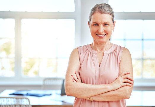 Female leader, manager and boss in an office boardroom for design standing arms crossed while looking confident. Portrait, management and startup with a mature business woman in an office in England