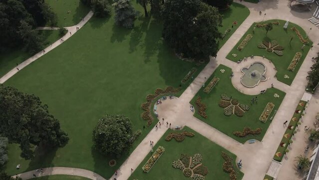Fountains and flower beds in Thabor gardens at Rennes, France. Aerial top-down forward