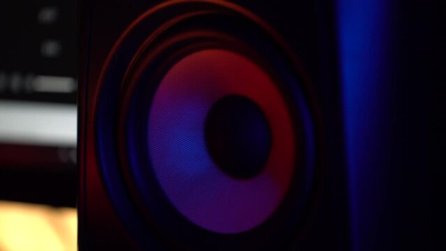 Dark candle lit heavy bass sub woofer speaker playing loud bass boosted music