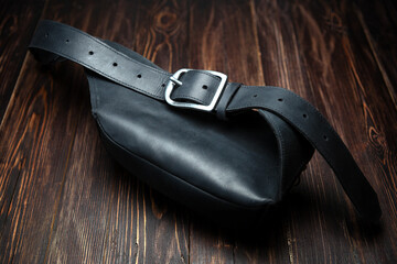 Black leather bag with belt, back view
