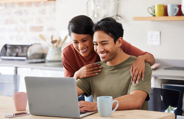 Laptop, internet and couple in communication on social media with coffee in the kitchen of their house. Man and woman with smile while reading an email on technology with drink of tea in the morning