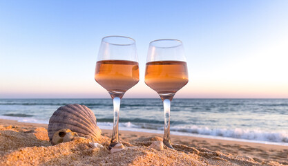 two glasses of wine on the beach ( romantic,  new year,  anniversary concept)