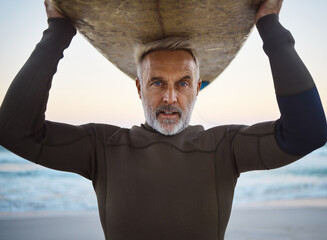 Beach, surf board on head and a mature surfer man with ocean waves and sea sand. Freedom, water...
