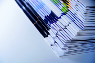 Stack of colorful magazines on a white background for designing publications and presentations