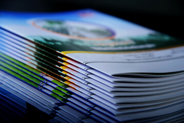 pile of annual report books on black background