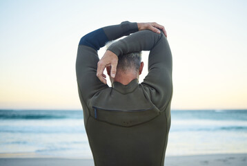 Fitness, surf and man stretching on beach to warm up before training in ocean water. Fitness,...