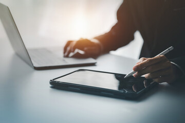 Business men are looking at the company's financial documents on tablets to analyze problems and...