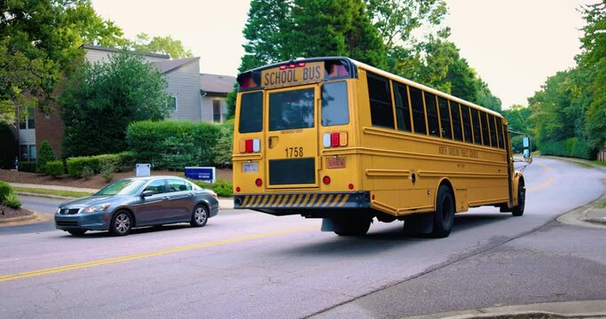 school bus is moving on the road in the morning