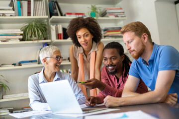 Group of happy business people discussing and working together during a meeting in office