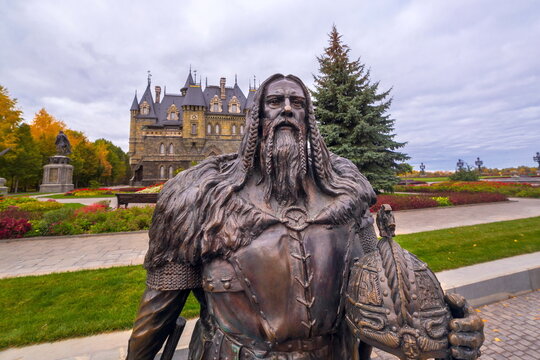 Russia, Samara region, September 2021: sculptures of a Scandinavian warrior in armor holding a battle ax in his hand. The village of Khryashchevka.