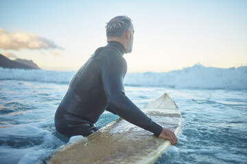 Senior man surfing in sea ocean, water waves in Australia sky and mental health retirement. Training body at beach for competition, summer exercise and travel surfer fitness lifestyle in peace nature