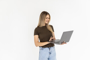Naklejka premium Portrait of a happy woman holding laptop computer while sitting on a floor over white background