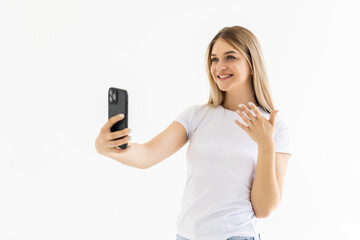 Fototapeta premium Happy woman chatting via video call and greeting with hand on a white background