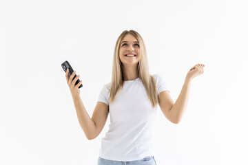 Young woman use smartphone impressed social media like feedback win raise fists scream yes over white grey background
