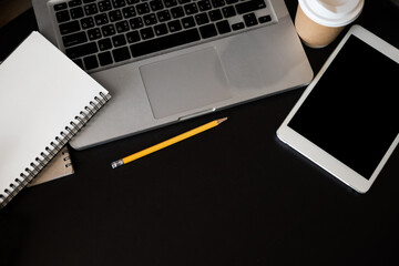 office desk table with a lot of things tablet, laptop ,smartphone ,notepad and coffee cup notepad . Top view with copy space