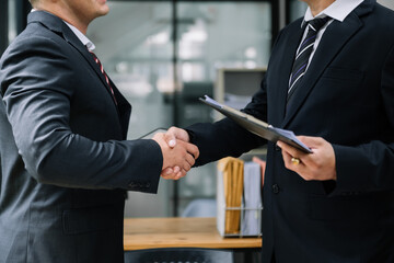 Business handshake closing a deal with blur background of people