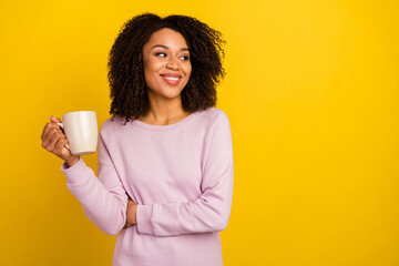 Photo of young pretty woman drink espresso wonder look empty space isolated over yellow color background