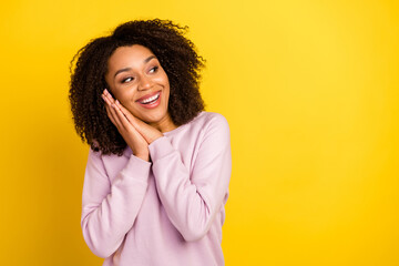 Photo of young lovely woman hands touch cheeks curious look empty space isolated over yellow color background