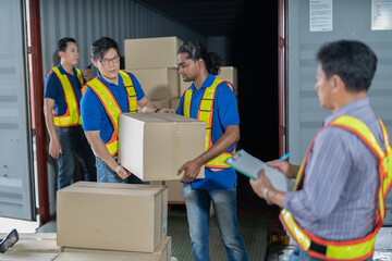 4 men Warehouse worker open doors steel 40 feet container and help carry box one by one supervisor...