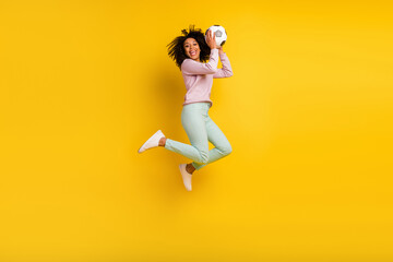 Fototapeta na wymiar Full size profile side photo of young lady jump up energetic catch ball isolated over yellow color background