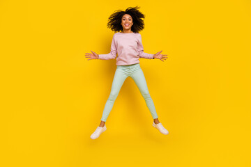 Fototapeta na wymiar Full length photo of young pretty woman have fun jump up carefree isolated over yellow color background