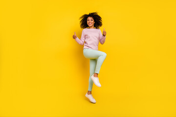 Fototapeta na wymiar Full size photo of young pretty woman jump show thumb-up approve perfect isolated over yellow color background