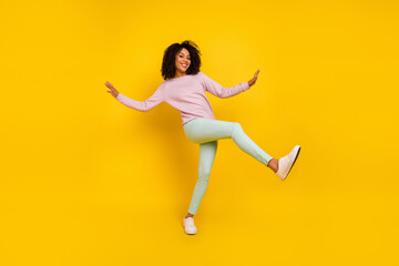 Fototapeta na wymiar Full body photo of young cheerful girl good mood dancer chill free-time isolated over yellow color background