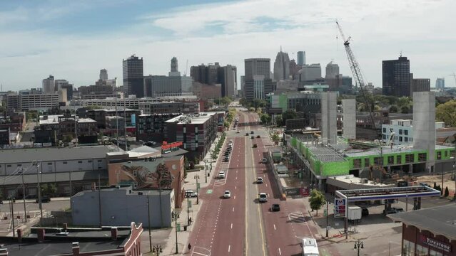 Detroit, Michigan skyline low view with drone video moving forward showing Woodward Avenue.