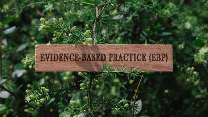 EBP education. Written on wooden surface. Background tree leaves. Education and work