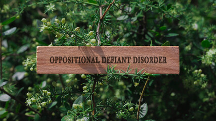 Oppositional Defiant Disorder . Written on wooden surface. Background tree leaves. health and sport.